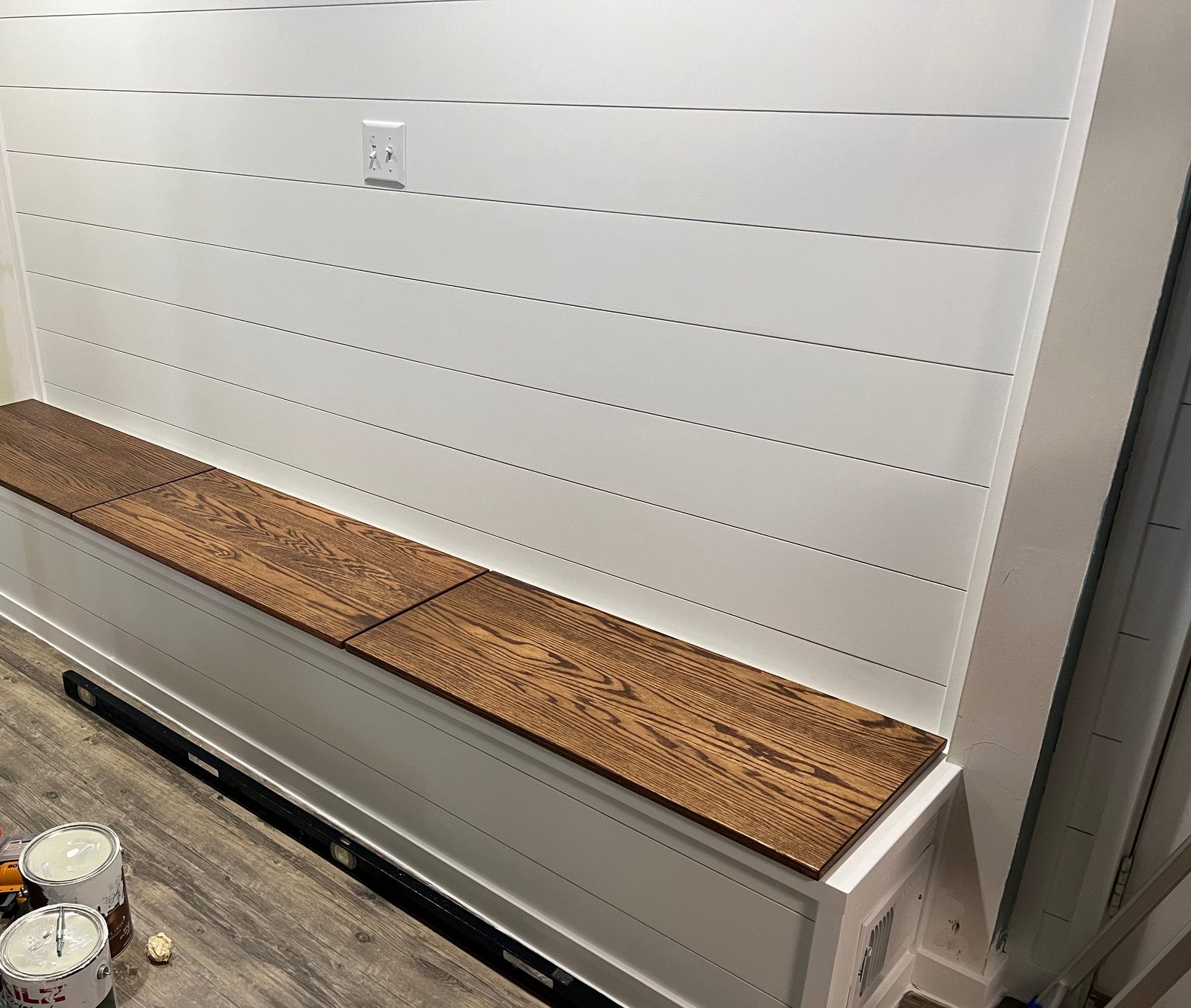 Built-in storage bench and shiplap wall